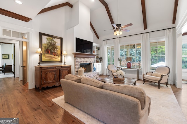 11660 Crabapple Rd, Roswell, GA 30075 - living room with ceiling fan, beam ceiling, a fireplace, wood-type flooring, and high vaulted ceiling