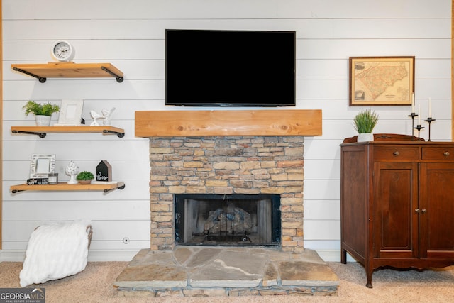 detailed view of carpet floors, a fireplace, and wooden walls