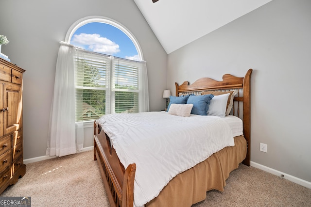 bedroom featuring vaulted ceiling, light colored carpet, and baseboards