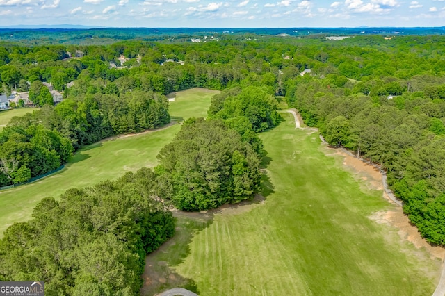 drone / aerial view of a forest and a golf course