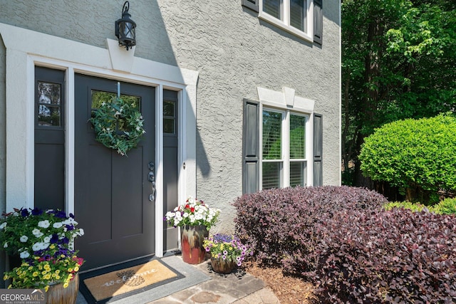 property entrance featuring stucco siding