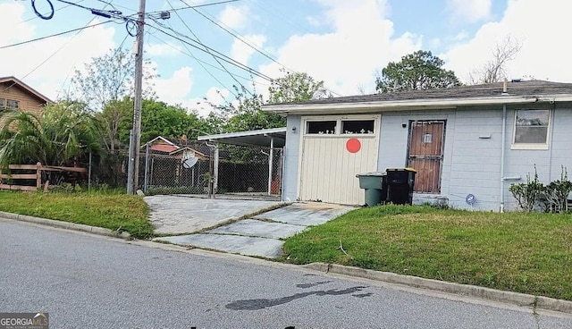view of outbuilding featuring concrete driveway and an attached carport