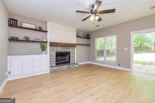 10 Queens Ct, Sharpsburg, GA 30277 - unfurnished living room with wood finished floors, ceiling fan, and a stone fireplace