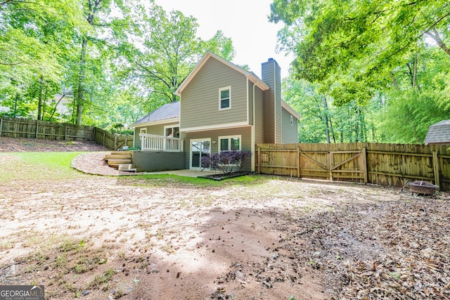 10 Queens Ct, Sharpsburg, GA 30277 - rear view of property with a chimney, a fenced backyard, a patio, and a gate
