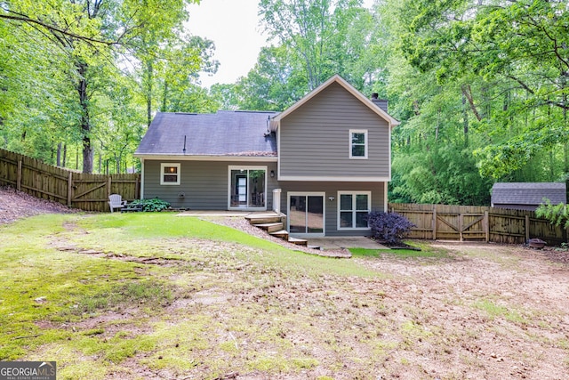 10 Queens Ct, Sharpsburg, GA 30277 - back of property featuring a gate, a fenced backyard, and a chimney