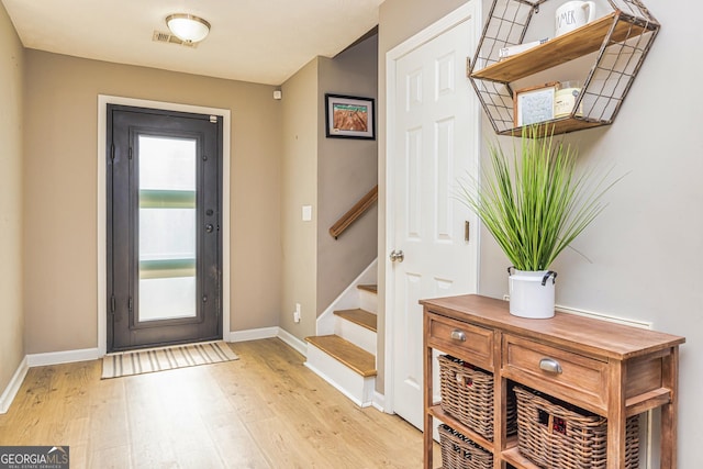 10 Queens Ct, Sharpsburg, GA 30277 - entryway with light wood-style flooring and stairway