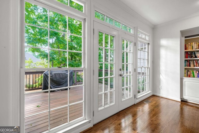 entryway with crown molding, wood finished floors, french doors, and baseboards
