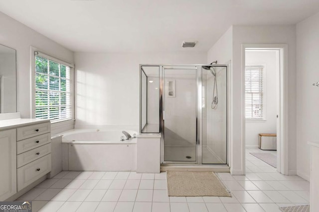 full bath featuring tile patterned floors, a stall shower, vanity, and a bath