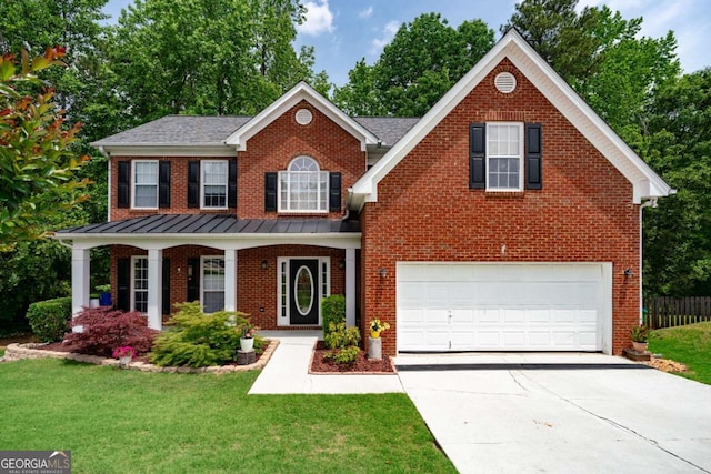 view of front of home with an attached garage, concrete driveway, brick siding, and a standing seam roof