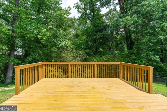wooden terrace featuring fence