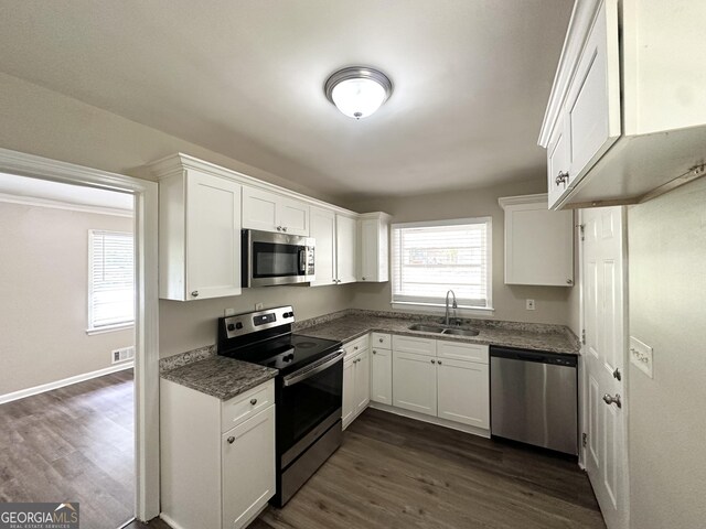 2165 Pemberton Rd, Atlanta, GA 30331 - kitchen featuring appliances with stainless steel finishes, a sink, white cabinetry, dark wood finished floors, and baseboards