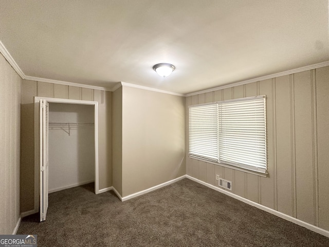 2165 Pemberton Rd, Atlanta, GA 30331 - unfurnished bedroom with crown molding, a closet, dark carpet, and baseboards