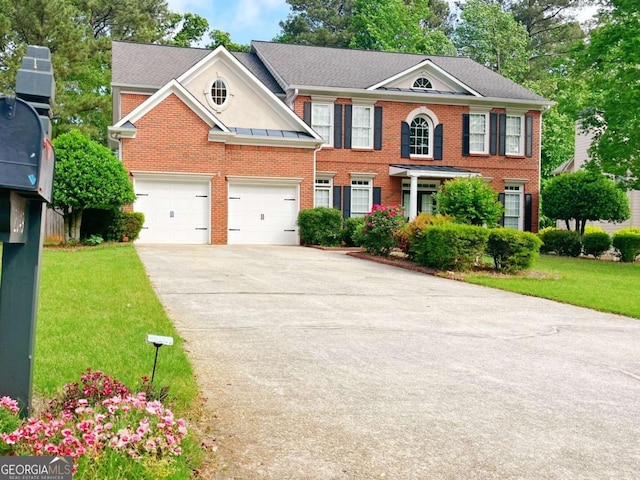 2049 Mclain Rd NW, Acworth, GA 30101 - colonial house featuring brick siding, driveway, a front lawn, and a garage