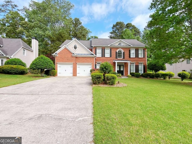 2049 Mclain Rd NW, Acworth, GA 30101 - colonial house with brick siding, driveway, a front yard, and a garage