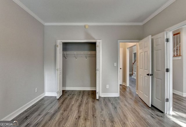 2049 Mclain Rd NW, Acworth, GA 30101 - unfurnished bedroom with ornamental molding, wood finished floors, baseboards, and a closet