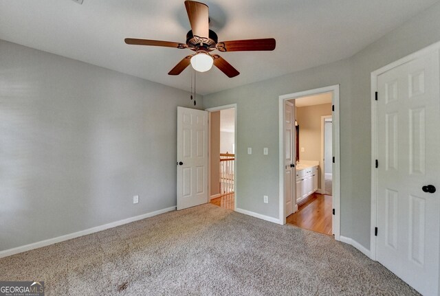 2049 Mclain Rd NW, Acworth, GA 30101 - unfurnished bedroom with light carpet, baseboards, connected bathroom, and a ceiling fan