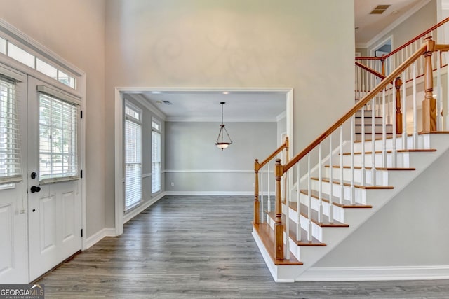 2049 Mclain Rd NW, Acworth, GA 30101 - foyer entrance with ornamental molding, a towering ceiling, wood finished floors, stairs, and baseboards