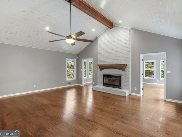 230 Shorewood Ct, Mcdonough, GA 30252 - unfurnished living room featuring high vaulted ceiling, ceiling fan, a brick fireplace, beam ceiling, and wood finished floors
