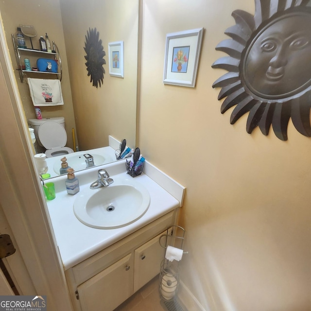 half bathroom with vanity and tile patterned flooring