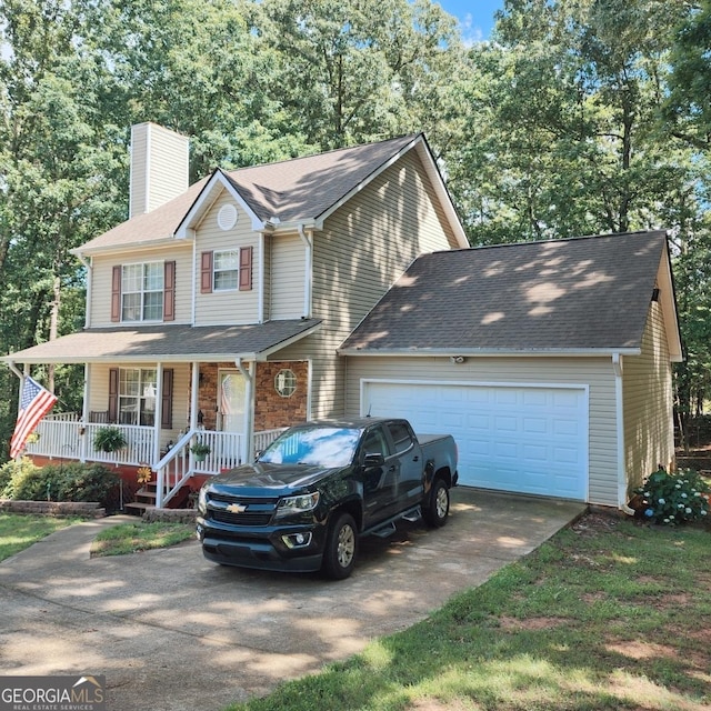 view of front of home with concrete driveway, a chimney, covered porch, an attached garage, and roof with shingles