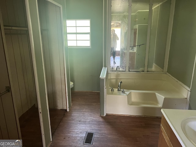 491 Cavender Creek Rd, Carrollton, GA 30116 - bathroom featuring a bath, wood finished floors, vanity, and toilet