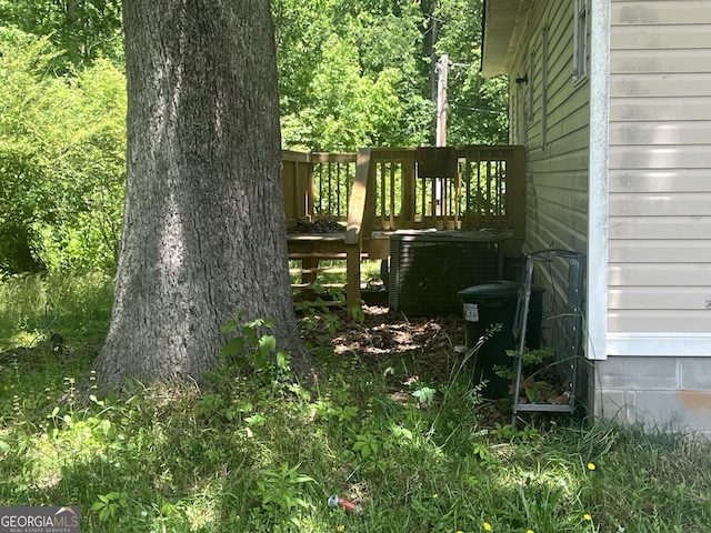 491 Cavender Creek Rd, Carrollton, GA 30116 - view of yard featuring central AC unit and a wooden deck