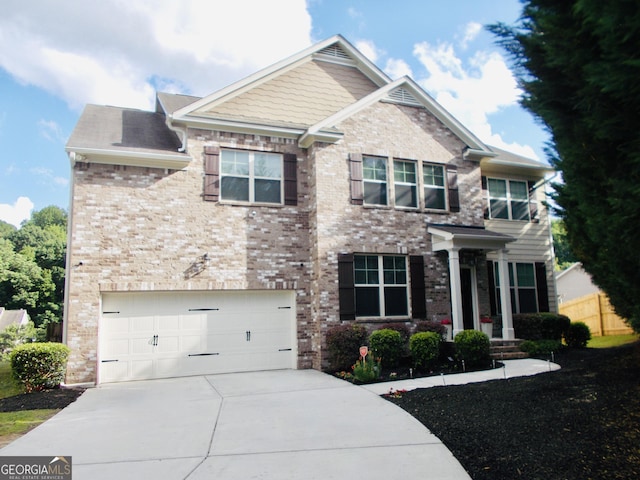 1720 Grant Ct, Braselton, GA 30517 - craftsman house featuring driveway, an attached garage, stone siding, and brick siding