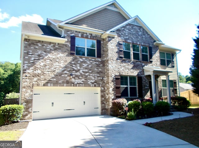 1720 Grant Ct, Braselton, GA 30517 - craftsman house featuring driveway, an attached garage, fence, and brick siding