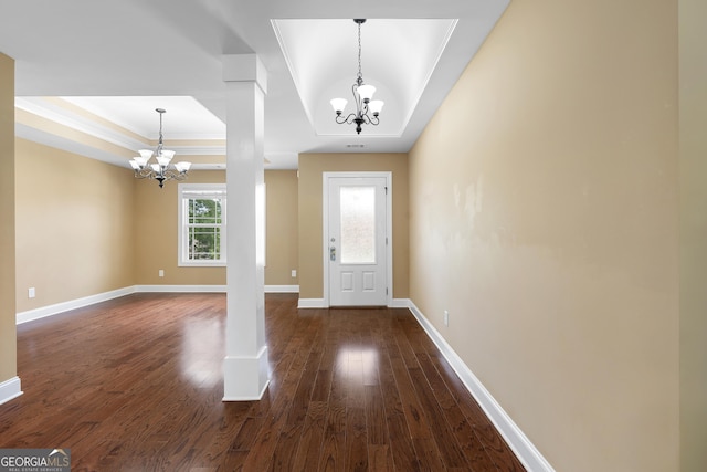 114 Brookstone Dr, Carrollton, GA 30116 - foyer entrance with a chandelier, a raised ceiling, dark wood-style floors, ornamental molding, and baseboards