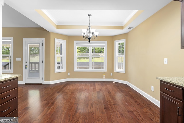 114 Brookstone Dr, Carrollton, GA 30116 - unfurnished dining area with a chandelier, a tray ceiling, dark wood finished floors, crown molding, and baseboards