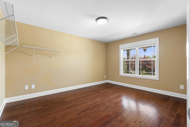 114 Brookstone Dr, Carrollton, GA 30116 - spare room featuring baseboards and dark wood-type flooring