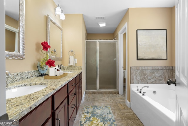 114 Brookstone Dr, Carrollton, GA 30116 - bathroom featuring a shower stall, double vanity, marble finish flooring, a bath, and toilet