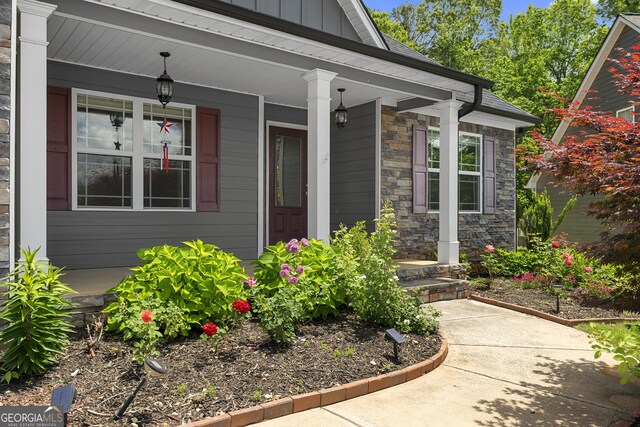 114 Brookstone Dr, Carrollton, GA 30116 - entrance to property with stone siding, covered porch, and board and batten siding