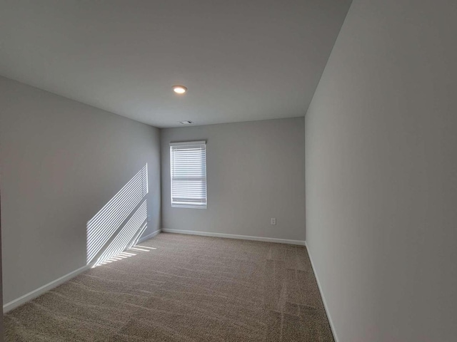carpeted spare room with baseboards and recessed lighting