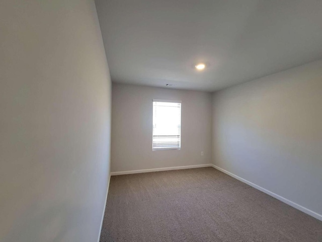 empty room featuring baseboards, carpet, and recessed lighting