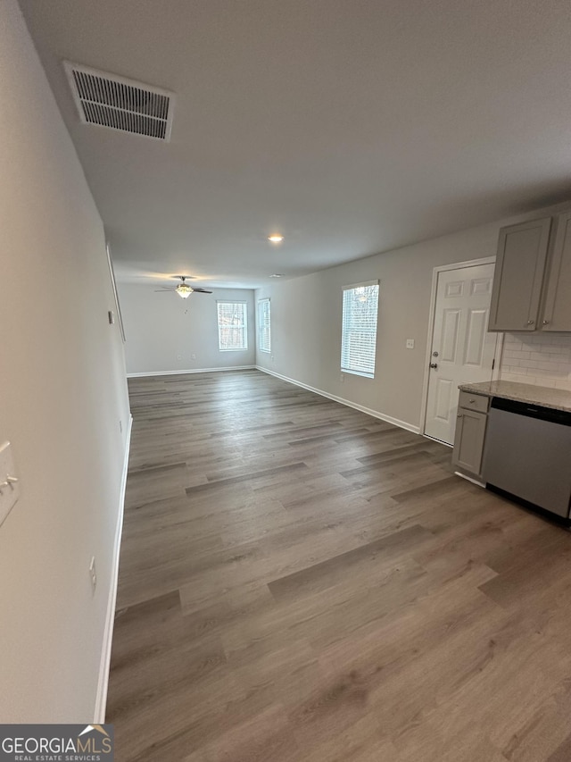 unfurnished living room with baseboards, light wood-style floors, ceiling fan, and recessed lighting
