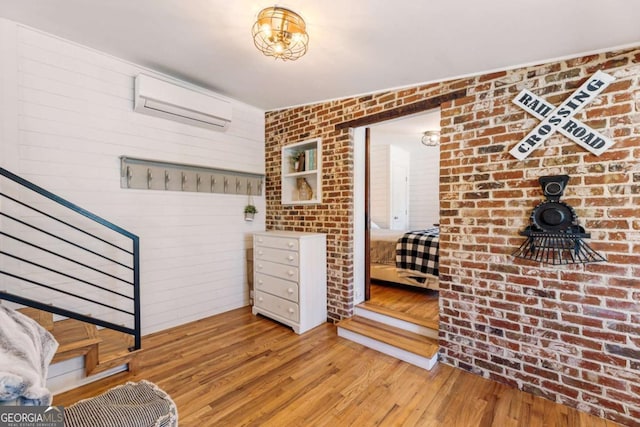 527 Main St, Suwanee, GA 30024 - entryway featuring a wall mounted AC, hardwood / wood-style flooring, stairs, and brick wall