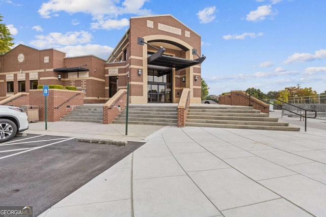 527 Main St, Suwanee, GA 30024 - view of property featuring uncovered parking and stairway