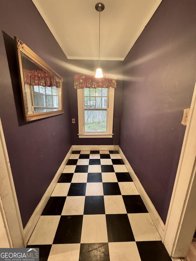 empty room featuring tile patterned floors and baseboards
