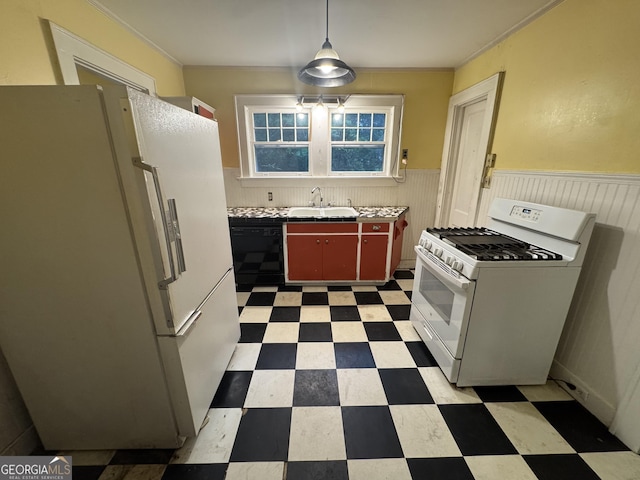 kitchen featuring white appliances, light floors, a wainscoted wall, a sink, and ornamental molding