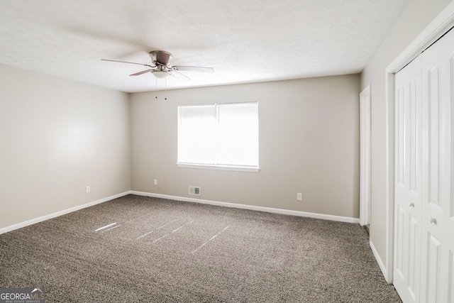 unfurnished bedroom with a closet, carpet floors, baseboards, and a textured ceiling