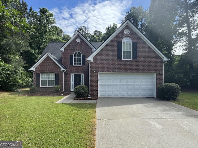 4551 Mitchells Meadow Ln, Ellenwood, GA 30294 - traditional-style house featuring driveway, a front yard, brick siding, and a garage