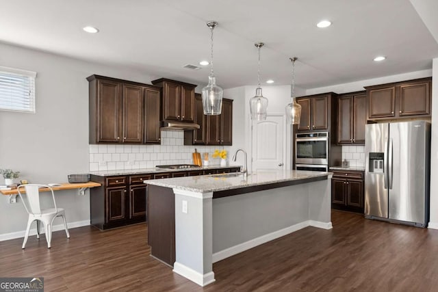 7995 Brewton Creek Dr, Cumming, GA 30028 - kitchen with appliances with stainless steel finishes, tasteful backsplash, dark brown cabinets, dark wood-style floors, and recessed lighting