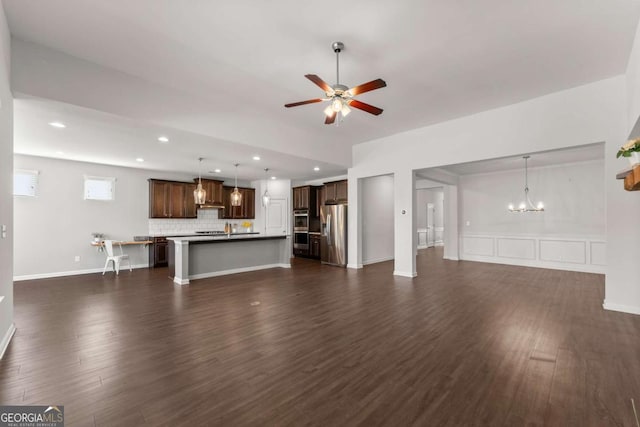 7995 Brewton Creek Dr, Cumming, GA 30028 - unfurnished living room with ceiling fan, dark wood finished floors, recessed lighting, and a chandelier