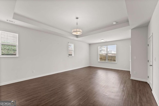 7995 Brewton Creek Dr, Cumming, GA 30028 - unfurnished room with a raised ceiling, dark wood-style floors, and baseboards