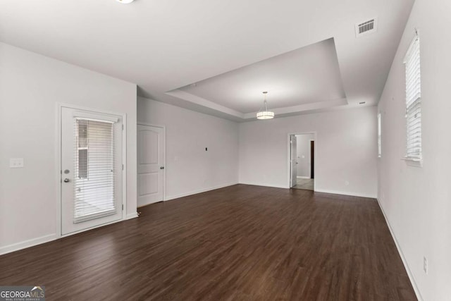 7995 Brewton Creek Dr, Cumming, GA 30028 - unfurnished living room with a raised ceiling, dark wood finished floors, and baseboards