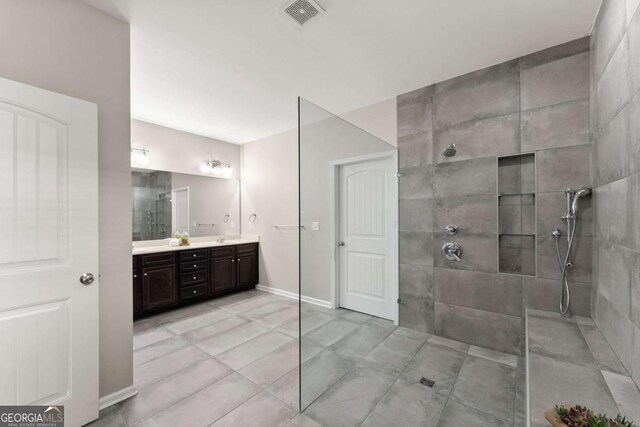 7995 Brewton Creek Dr, Cumming, GA 30028 - bathroom featuring walk in shower, double vanity, tile patterned floors, and baseboards