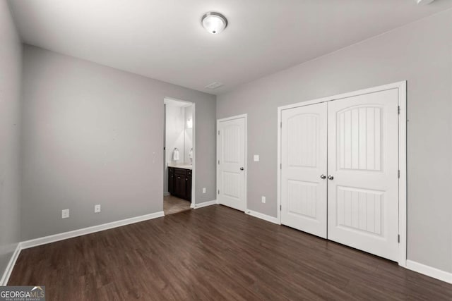 7995 Brewton Creek Dr, Cumming, GA 30028 - unfurnished bedroom with dark wood-style flooring, baseboards, a closet, and ensuite bathroom