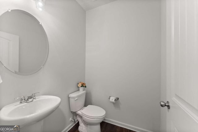 7995 Brewton Creek Dr, Cumming, GA 30028 - bathroom featuring a sink, toilet, wood finished floors, and baseboards