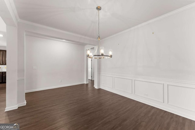 7995 Brewton Creek Dr, Cumming, GA 30028 - unfurnished dining area with a chandelier, dark wood finished floors, ornamental molding, and wainscoting